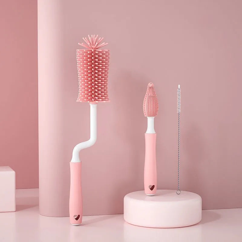 Silicone baby bottle cleaning brush and separate straw cleaner in pink, blue, and yellow colours.