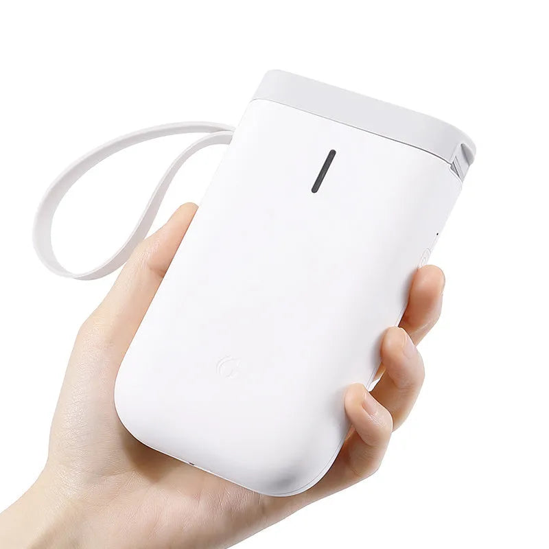 Compact D11 Bluetooth thermal label printer in black, white, pink, or green with smartphone showing label design app.