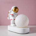 Gold resin astronaut night light on shelf, 14.5cm tall figurine with soft glow