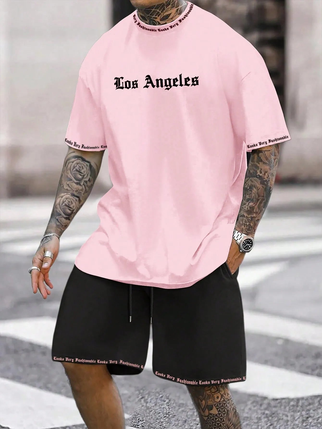Sports style short-sleeved top and matching shorts set laid flat, showing thin polyester blend fabric.