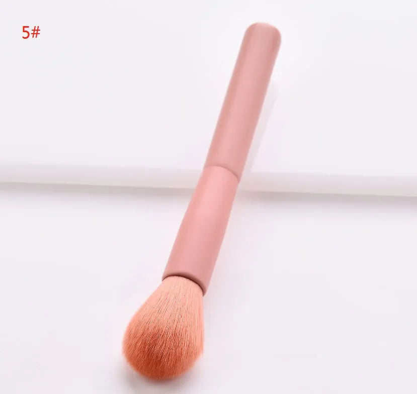 Open case showing 10 pink-handled makeup brushes including loose powder, foundation, flat head, and double-ended brushes.