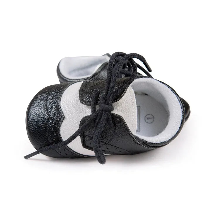 Vintage style baby walking shoes with soft soles and synthetic leather uppers in multiple colours
