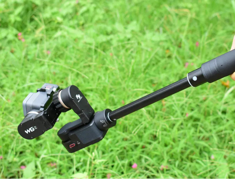 Black retractable lengthened selfie stick extended as a hand-held stabiliser