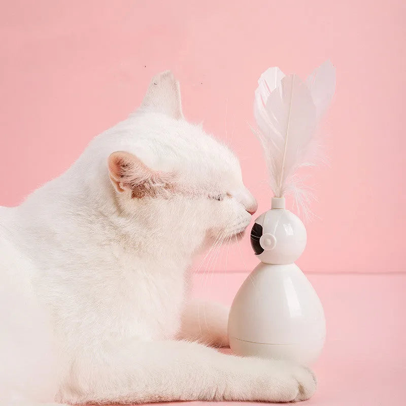 Tumbler funny cat artifact toy in pink with replacement feathers, made from ABS plastic, on a light background
