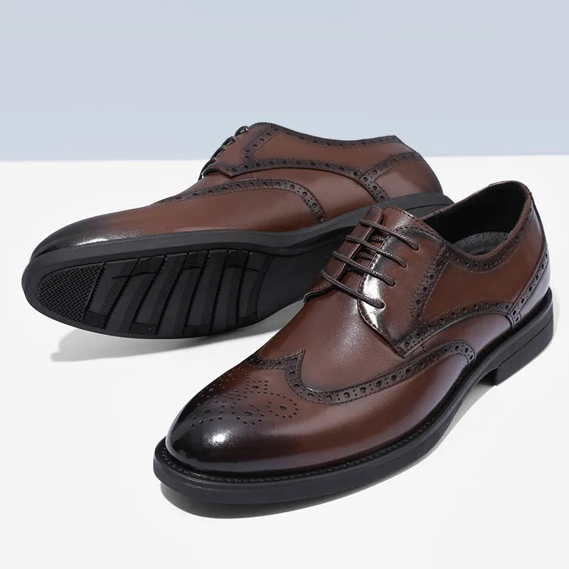 Men's black and brown brogue leather shoes with decorative perforations, shown on a white background.