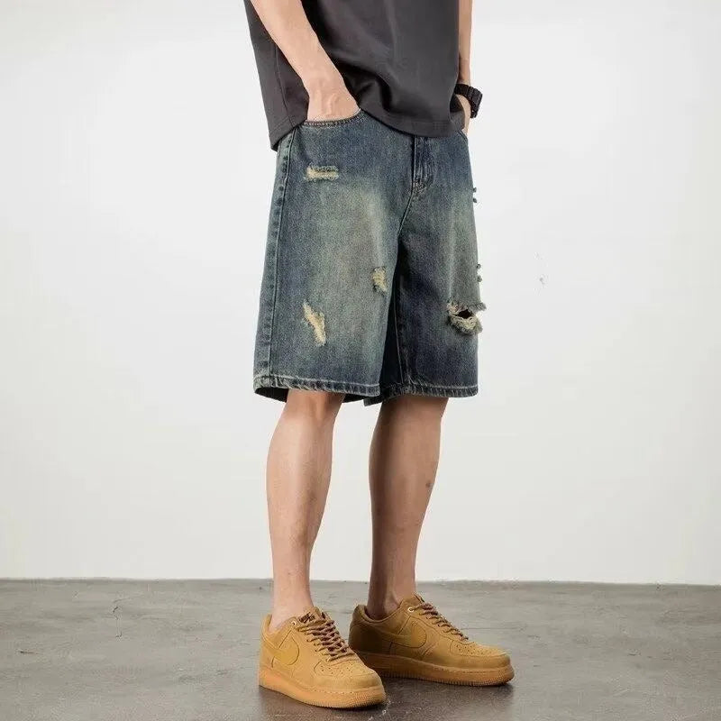 Blue retro loose hole denim shorts for men on a white background