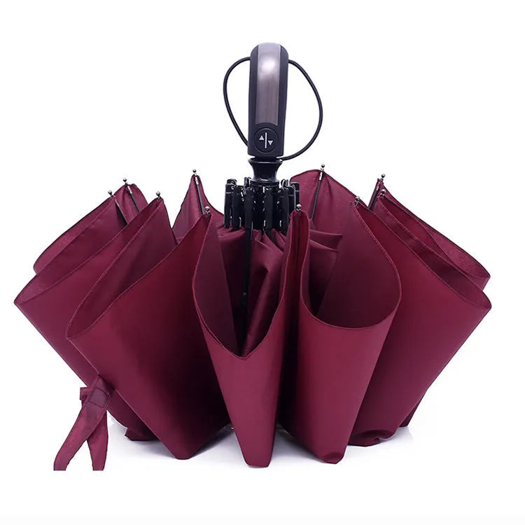 Black automatic open triple folding business umbrella with 10 ribs, shown in open position.