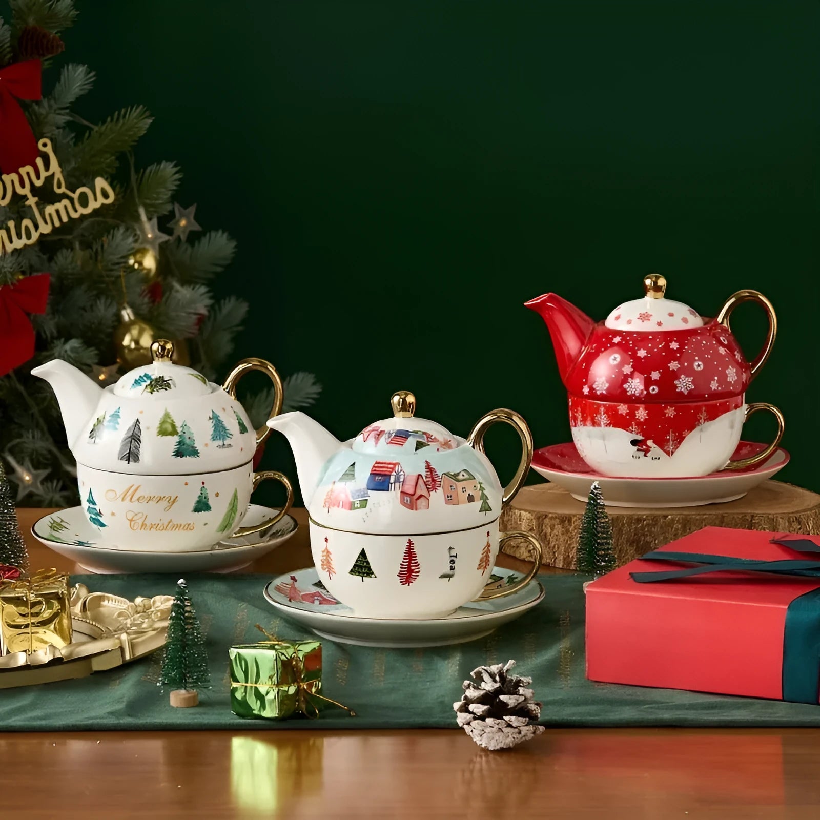 Ceramic gold-plated Christmas teapot set with snowflake design, including pot on dish and cup on dish with spoon, in gift box.
