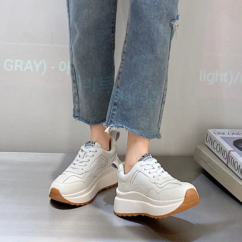 Beige women's low-top leather casual sports shoes with lace-up fastening and round toe.