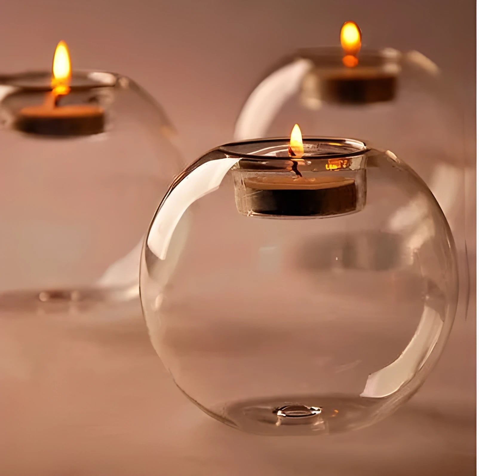 Handmade European hollow glass candle holder in round geometric design on table.