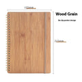 Erasable coil notebook with customisable cover options on waterproof rock stone paper, shown with pen.
