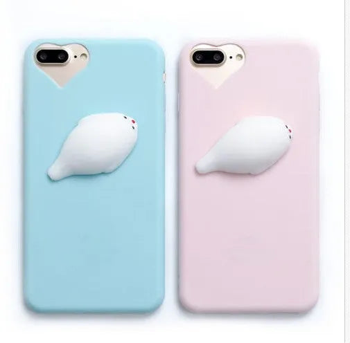A soft pink silicone iPhone case featuring a raised 3D cartoon cat design on the back.