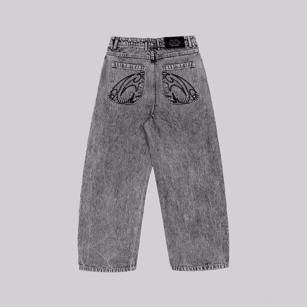 Grey loose straight-leg denim trousers on hanger showing mid-waist design and cotton fabric texture
