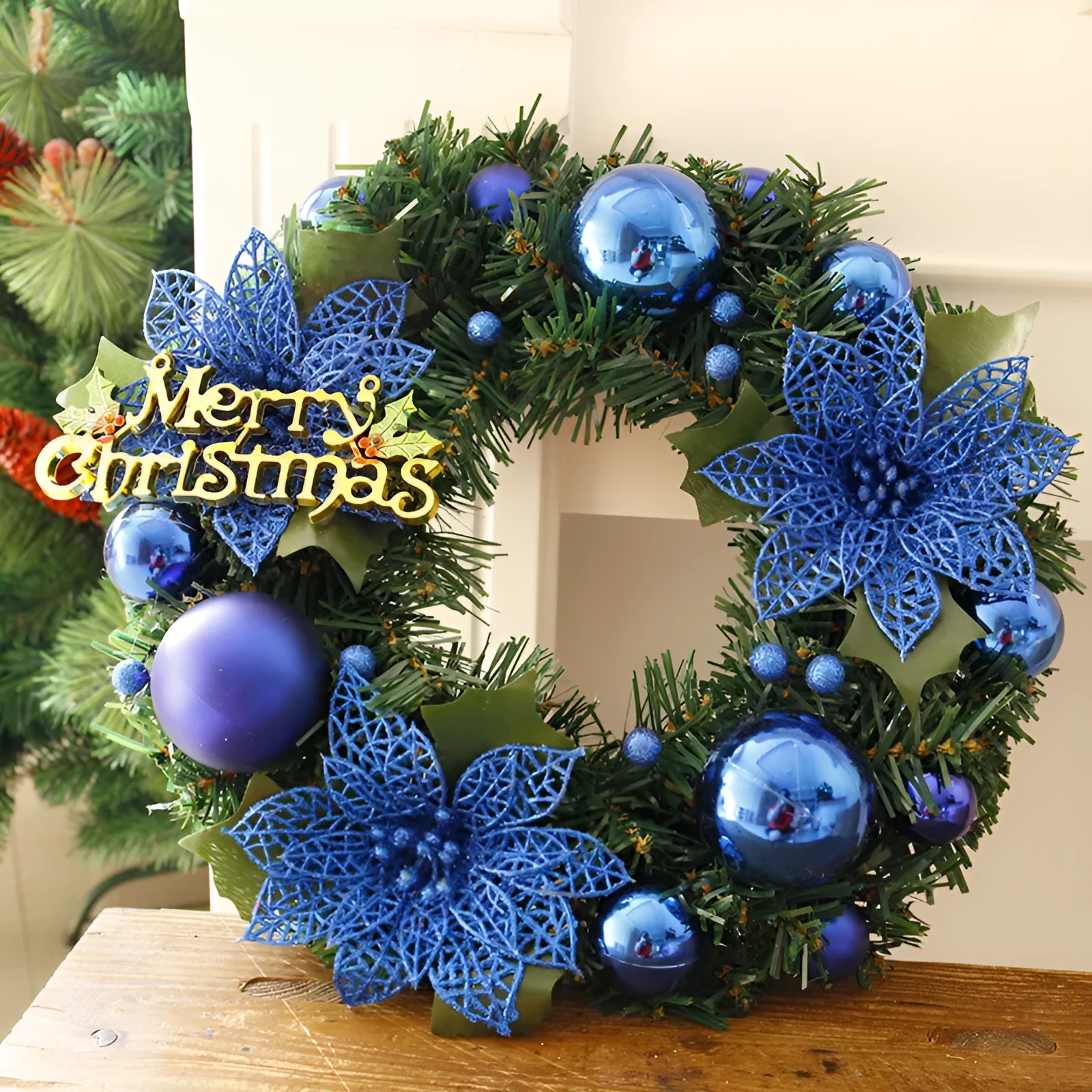 Multicolour plastic Christmas wreath with a 30cm diameter, shown in red against a door.
