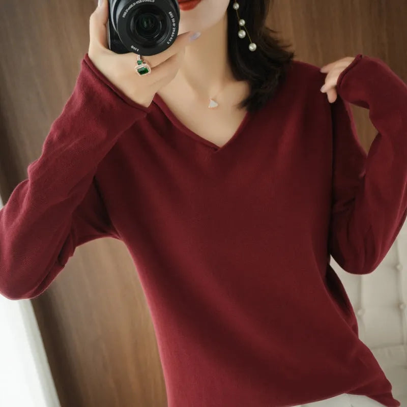 Women's V-neck long sleeve knitwear pullover top in a non-ironing material on a hanger.