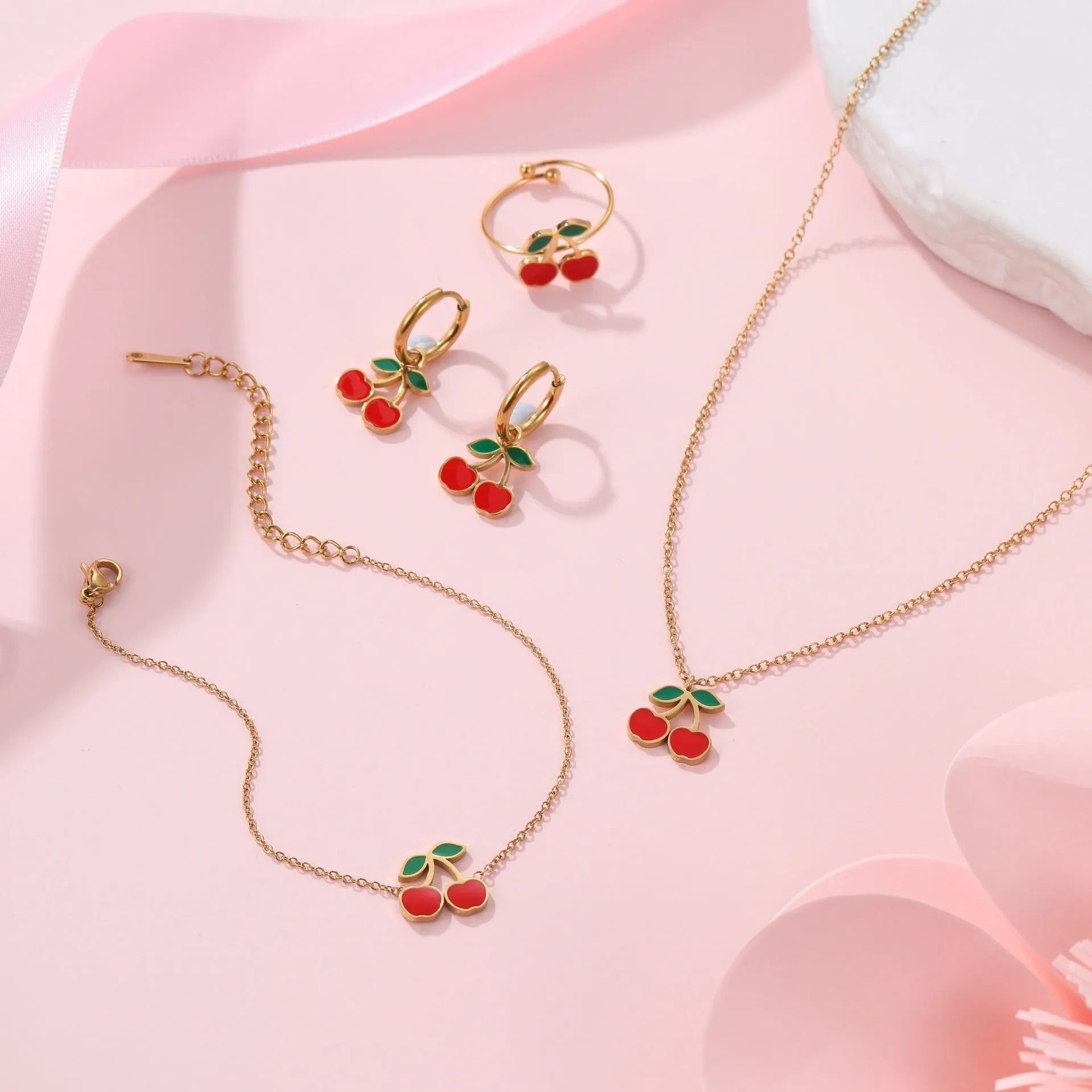 Stainless steel cherry jewellery set with necklace, bracelet, earrings, and ring in golden electroplated finish