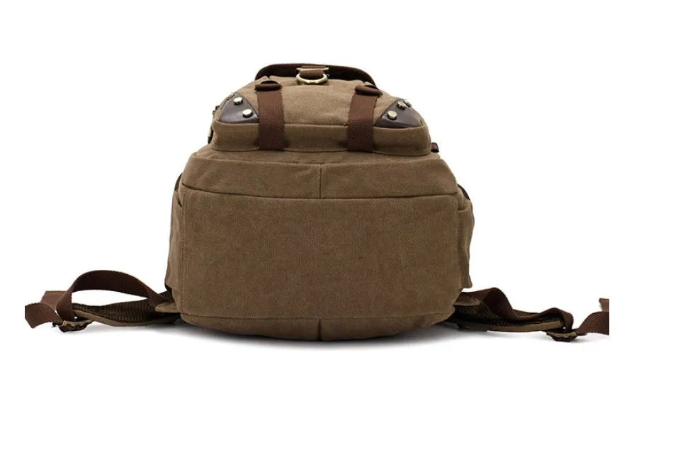 Canvas computer backpack in black with square vertical shape, zip closure, and multiple pockets