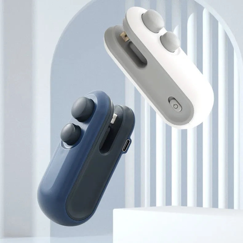 White and blue handheld USB rechargeable bag heat sealer with built-in cutter on a kitchen counter