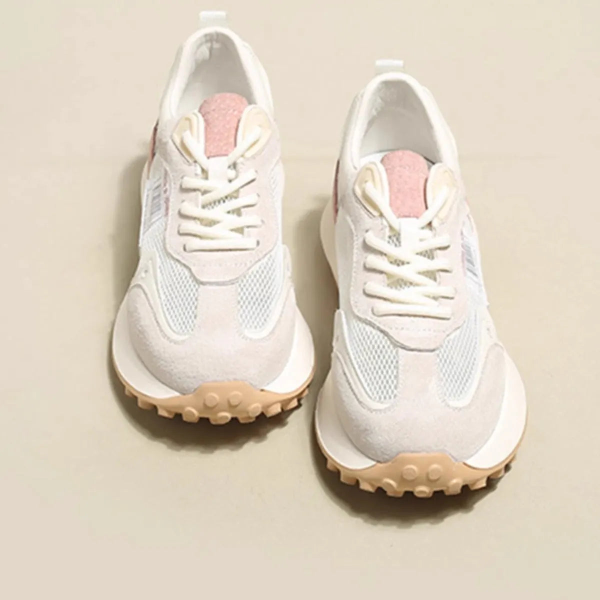 Women's gray and pink retro sneakers with mesh lining, rubber sole, and low-top design
