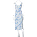 Women's long blue dress with lace flower print, suspender straps, and a high side slit.