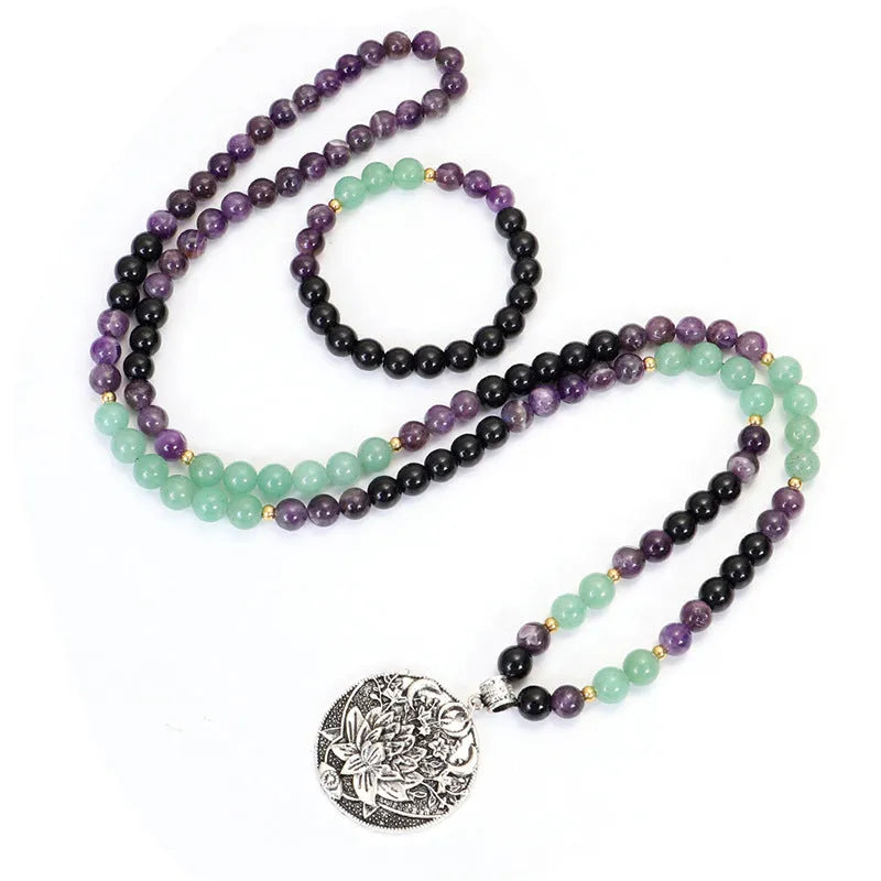 Yoga necklace with geometric lotus pendant and stone bead chain alongside a matching bracelet