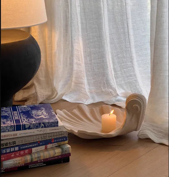 White resin shell-shaped ornament for fruit plate decoration on a table