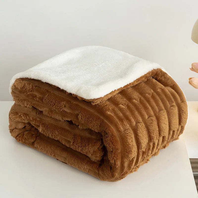 Rabbit Bejirog solid colour polyester fibre flange blanket on a bed, available in multiple sizes and colours