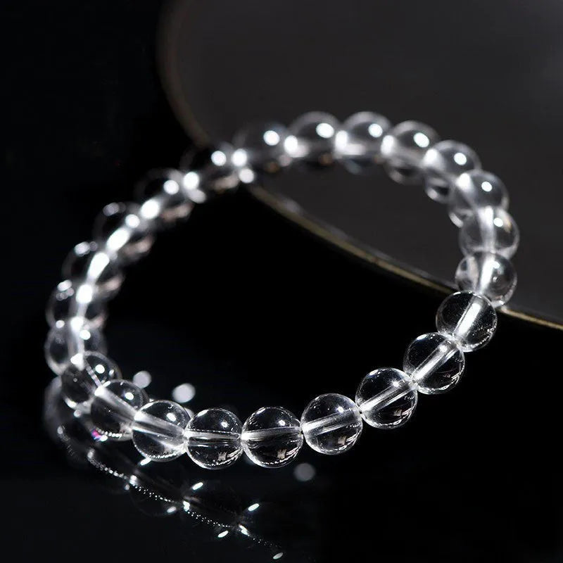 Natural Donghai old materials white water round crystal bracelet with geometric design on wrist.