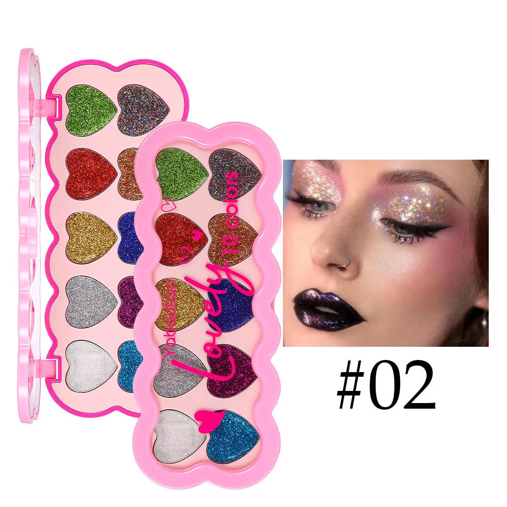 Pearlescent heart design eye shadow palette showing ten colours including white, beige, pink, purple, brown, blue, black, royal blue, maroon, and coral
