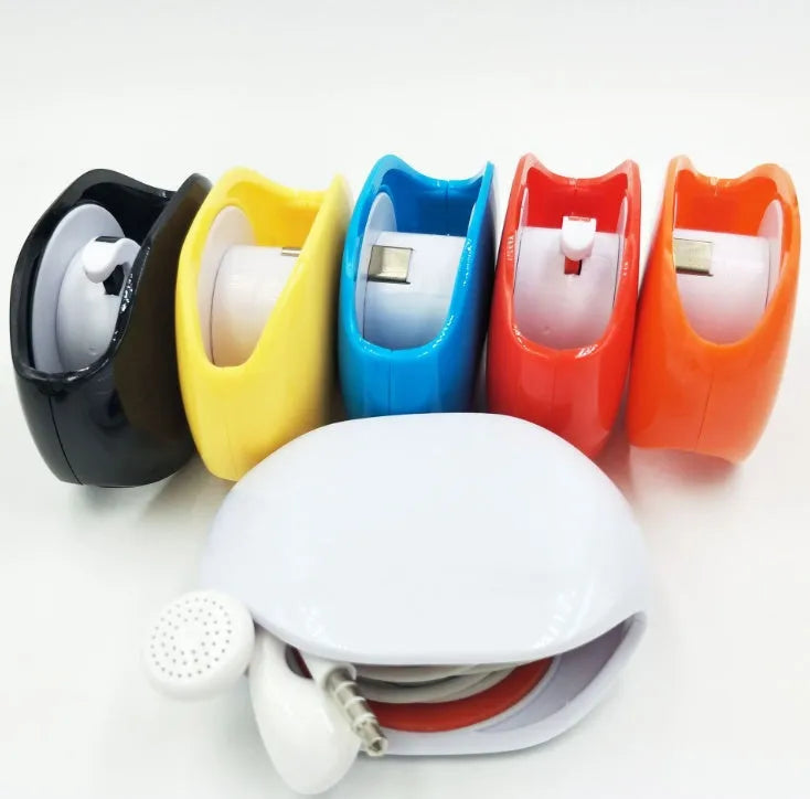 Automatic earphone cable retractor winder in a compact plastic storage box.
