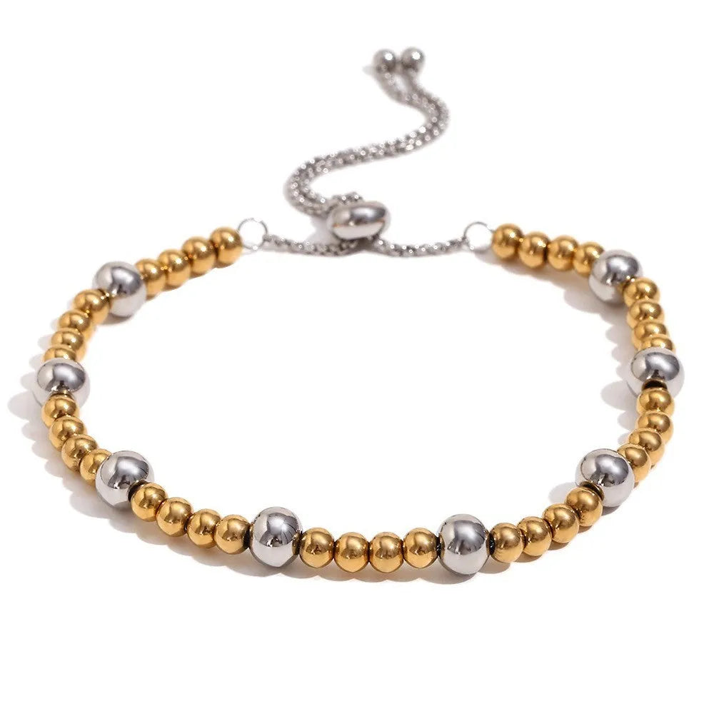 Gold electroplated geometric jewellery set with earrings, bracelet and necklace on white background