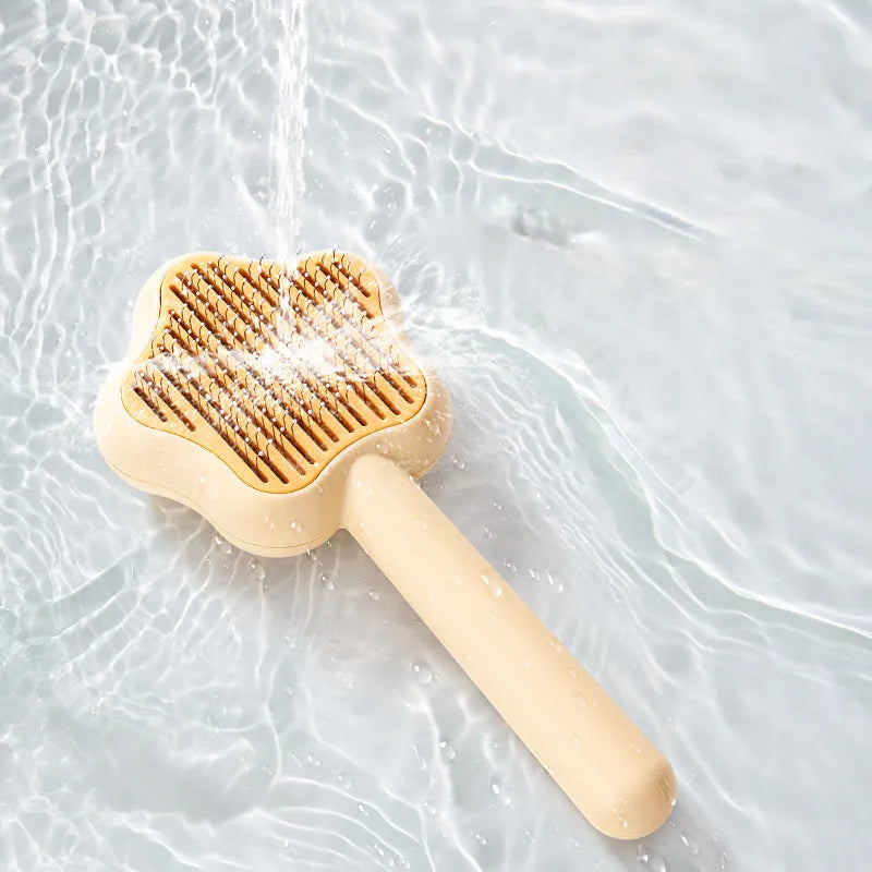 Green self-cleaning cat comb with stainless steel needles measuring 20 cm long