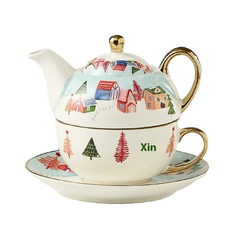 Ceramic gold-plated Christmas teapot set with snowflake design, including pot on dish and cup on dish with spoon, in gift box.