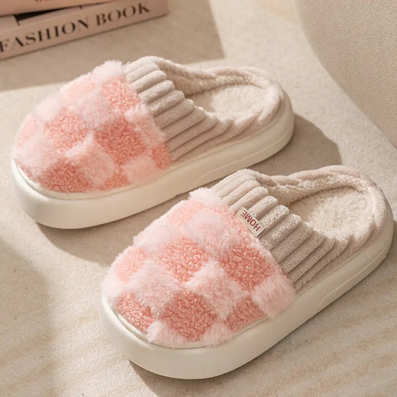 Women's plaid patterned plush slippers with non-slip sole in multiple colours on a wooden floor.