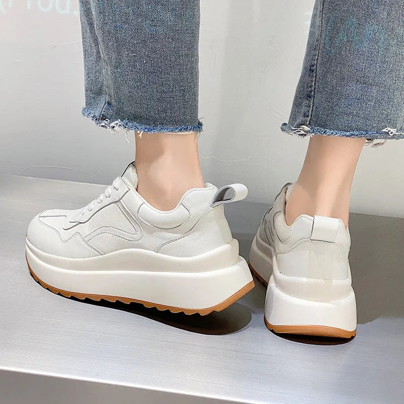 Beige women's low-top leather casual sports shoes with lace-up fastening and round toe.