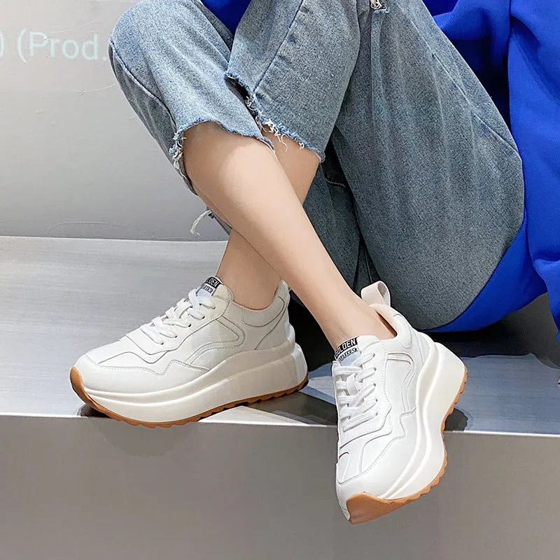 Beige women's low-top leather casual sports shoes with lace-up fastening and round toe.