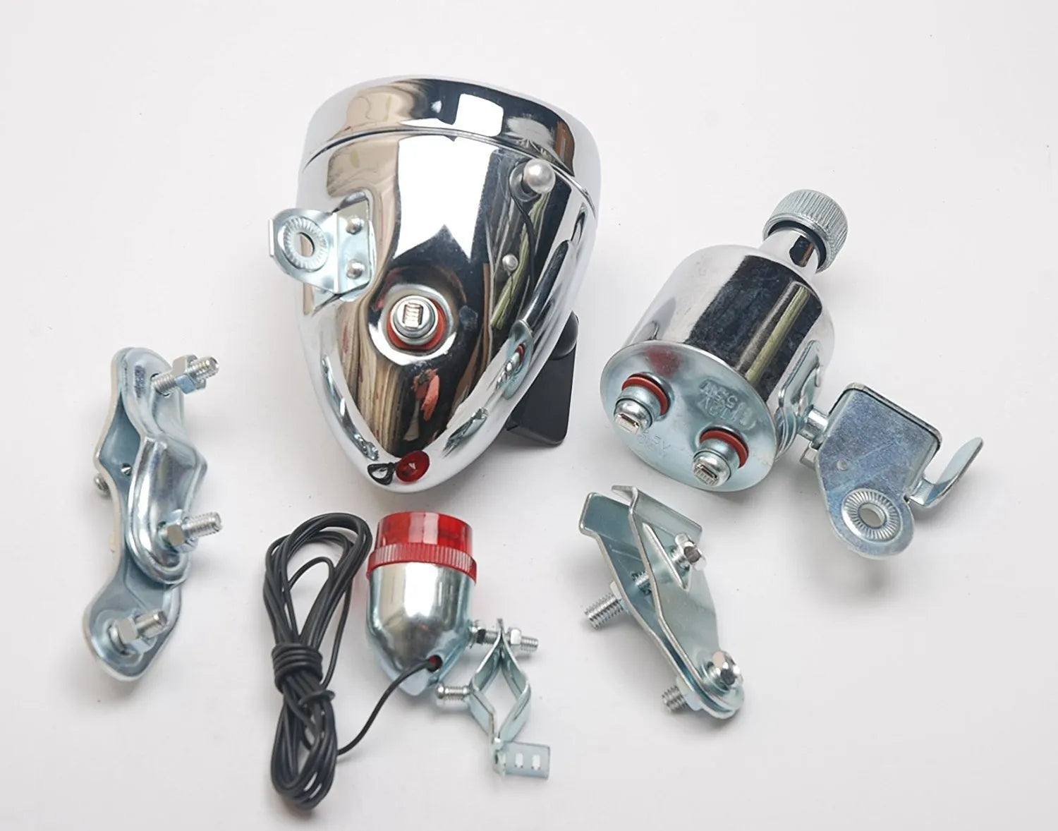 Silver aluminium bicycle dynamo light kit mounted on a bike fork for friction-powered lighting.