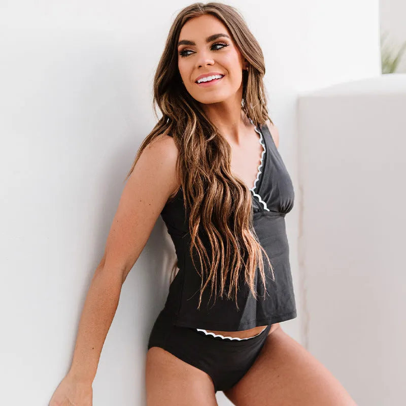 Black solid colour women's swimsuit bikini set with sleeveless design on mannequin