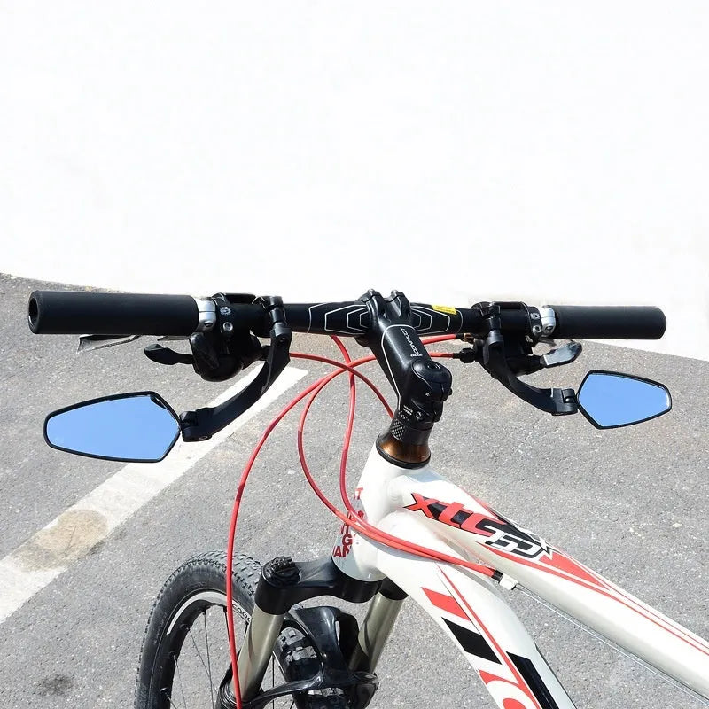 Black rotatable bicycle rearview mirror with large acrylic reflective surface mounted on handlebars.