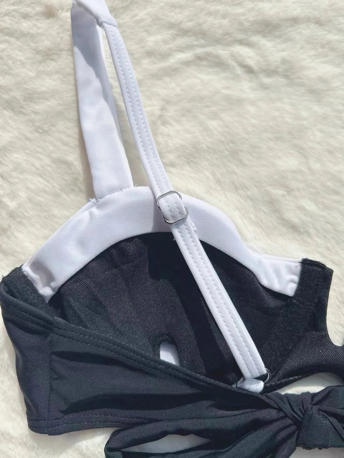 Black low waist women's bikini swimsuit with stitching detail and split briefs design