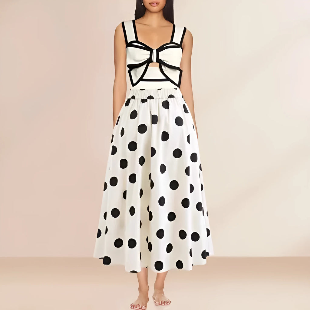 Women's black one-piece swimsuit with a white round skirt and a central bow detail.