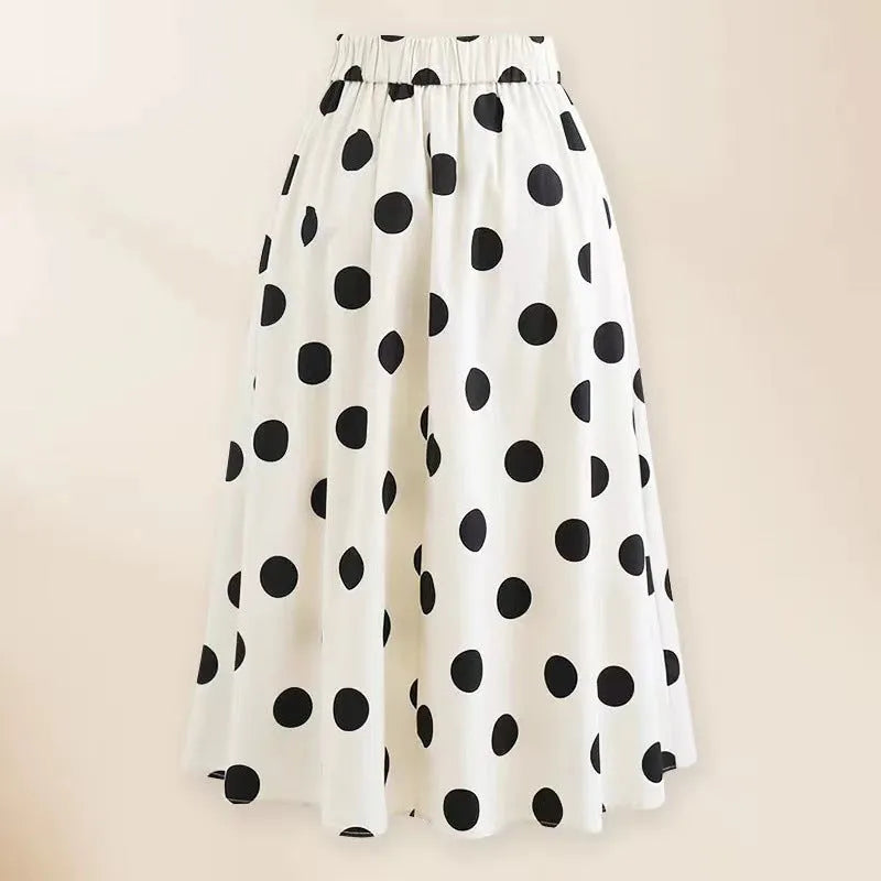 Women's black one-piece swimsuit with a white round skirt and a central bow detail.