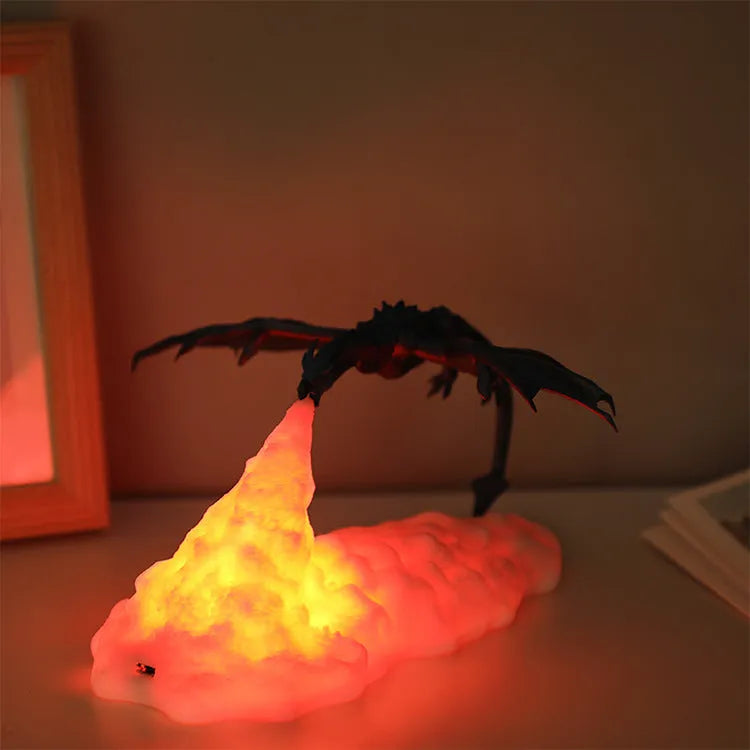 3D printed red dragon night light glowing on a surface with USB charging cable