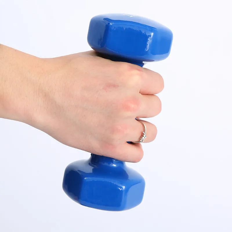 Brightly coloured plastic fitness dumbbells in 0.5kg, 1kg, and 1.5kg weights on a light background