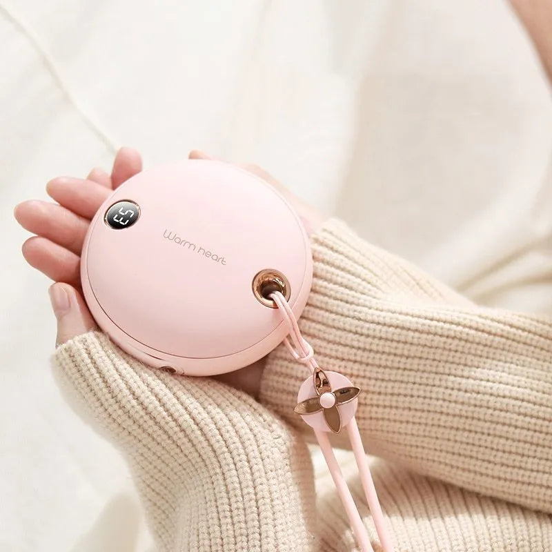 Green portable power bank with digital display and integrated hand warmer heater for phone charging