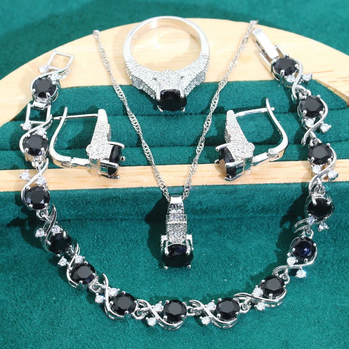 Four-piece bridal jewellery set with water wave chain necklace, bracelet, earrings, and ring in alloy with zircon detailing