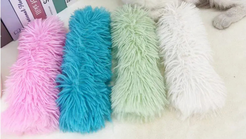 Plush cat toy pillow in blue, green, pink, or white colours measuring 27cm long by 10cm wide