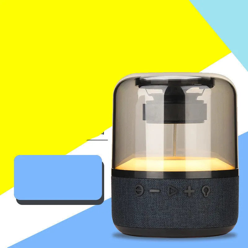 Black wireless Bluetooth speaker with touch controls, showcasing its compact design and 360-degree sound output.