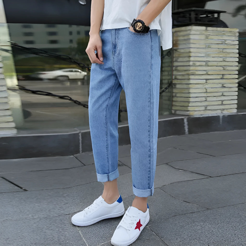 Men's straight leg cotton jeans in black and blue colours on a size chart background.