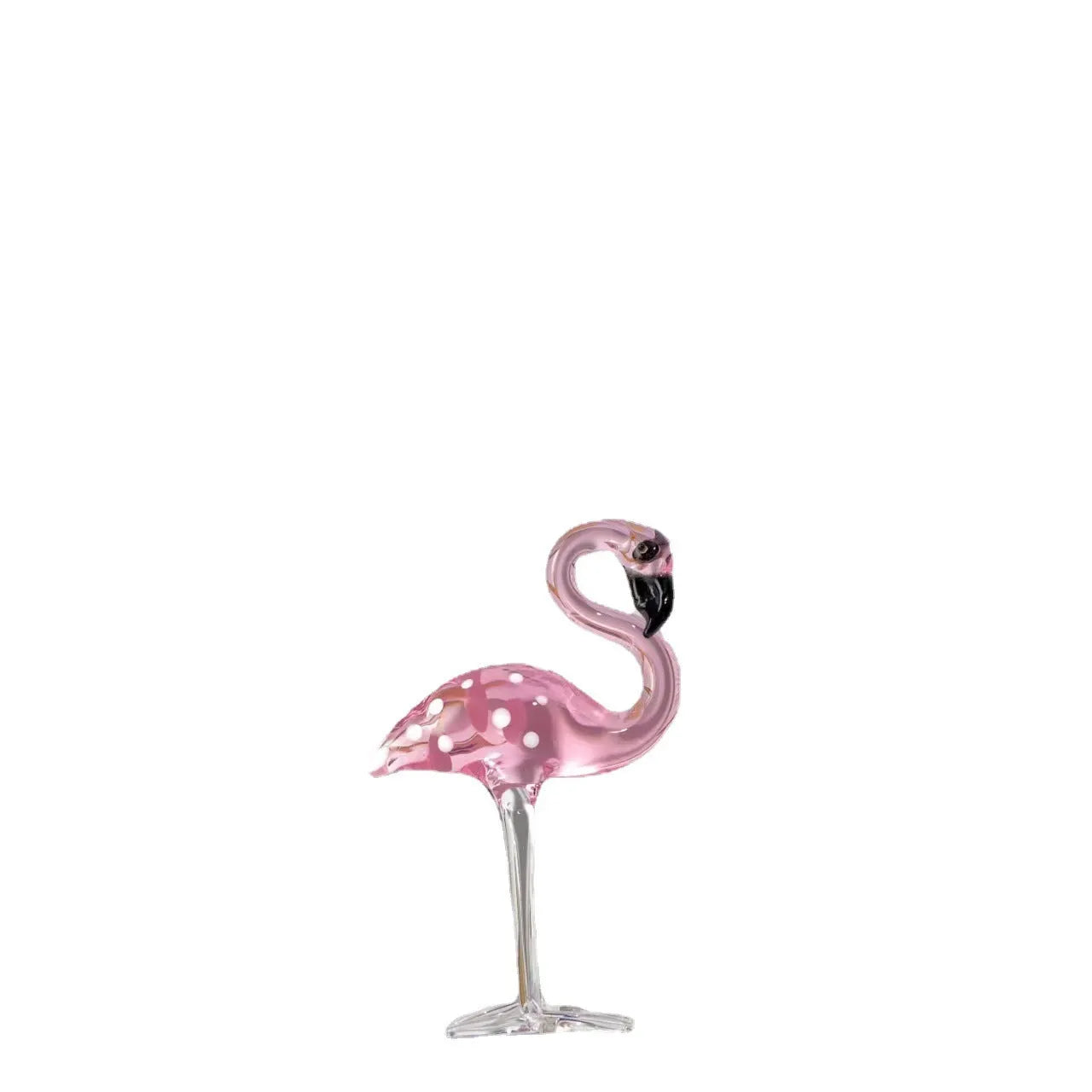 White crystal flamingo decorative ornaments with pink dots on a table